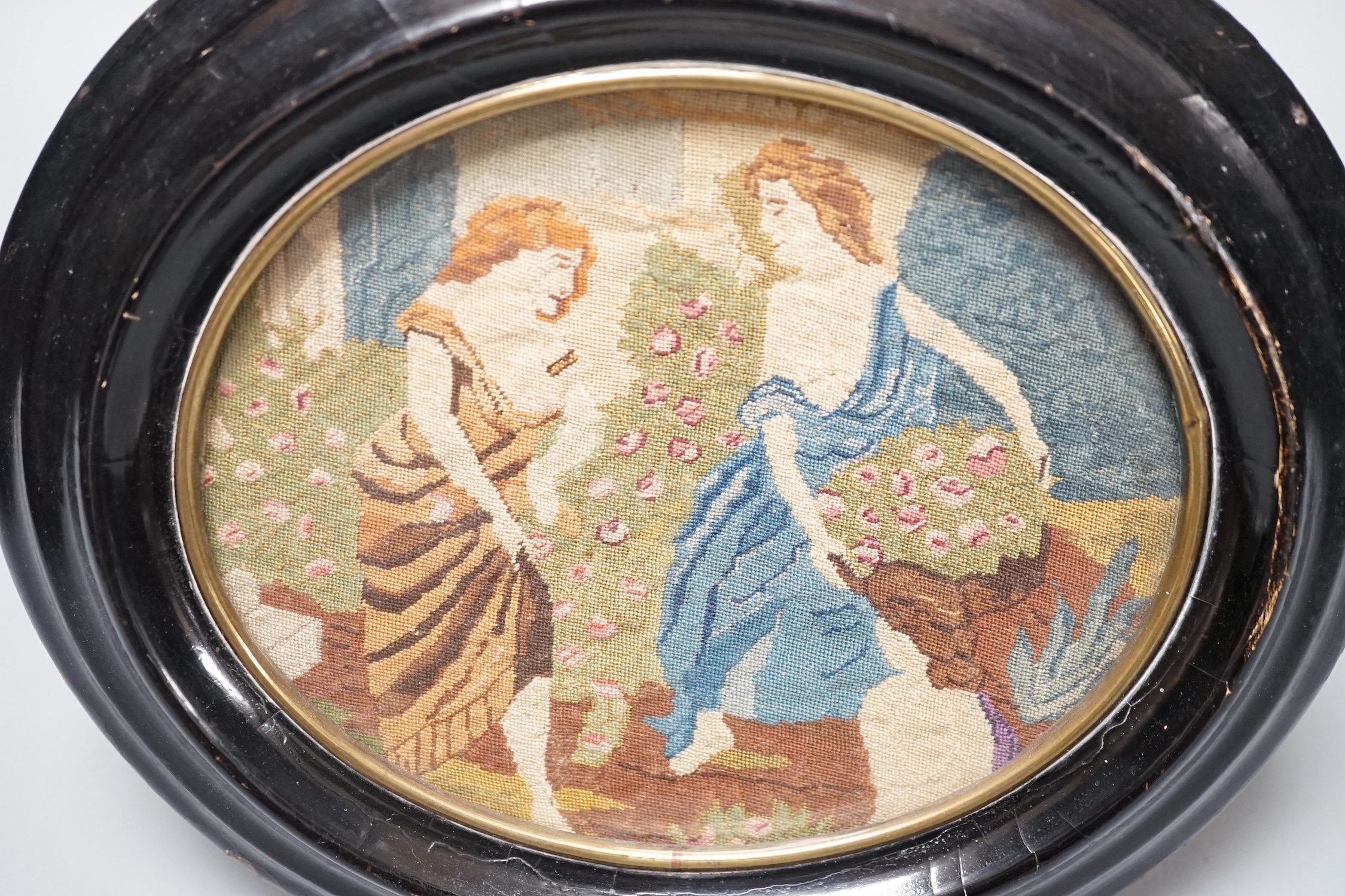 A 19th century oval petit point needlework picture, depicting women collecting flowers 12x15cm